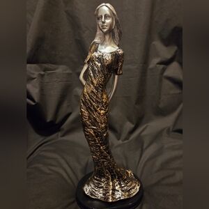 Beautiful Lady Statue In Casual Pose In A Gold/Black Dress